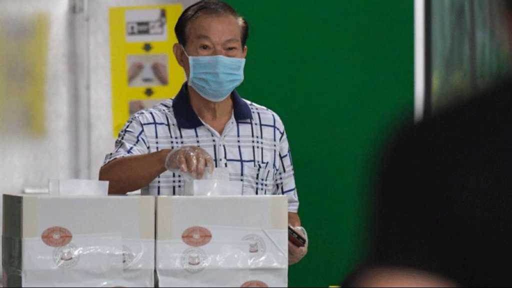 Les Singapouriens votent sous strict contrôle sanitaire